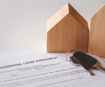 image of wooden house and lease contract and set of key